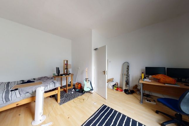 A Bright And Tidy Single Bedroom Featuring A Woode...