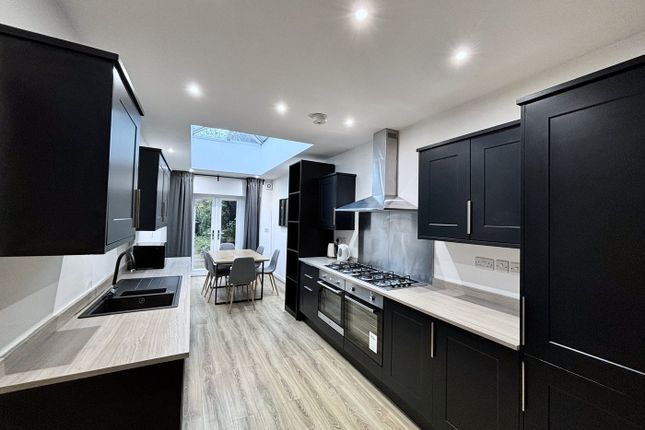 A Modern And Spacious Kitchen Featuring Sleek Blac...