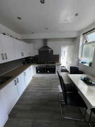 Bright And Modern Kitchen Featuring Ample Countert...