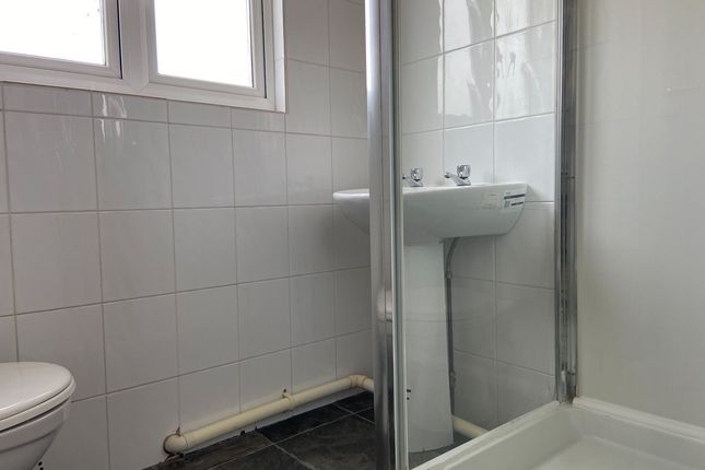 A Clean And Functional Bathroom With A Shower Unit...