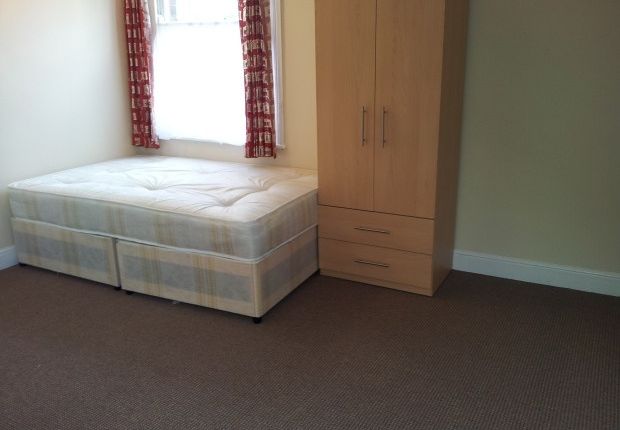 A Simple, Clean Single Bedroom Featuring A Bed Wit...