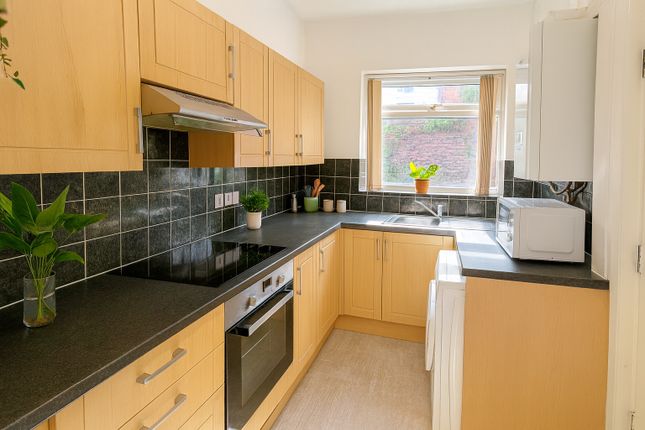 Bright And Modern Kitchen Featuring Wooden Cabinet...
