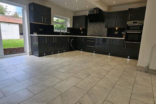 Spacious Modern Kitchen Featuring Sleek Black Cabi...