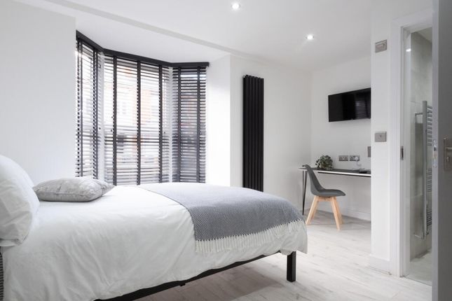 Bright And Modern Master Bedroom Featuring A Comfo...