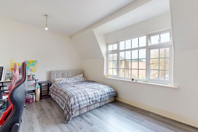 A Bright And Airy Bedroom With A Large Window Allo...