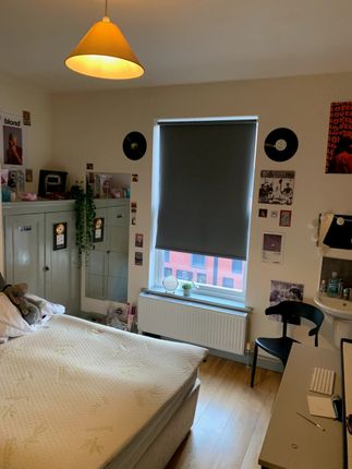 A Cozy Double Bedroom Featuring A Comfortable Bed,...