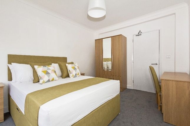 A Neatly Arranged Double Bedroom Featuring A Comfo...