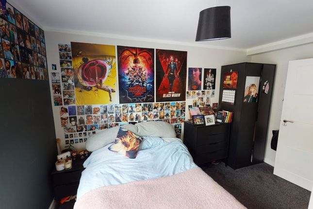 A Cozy Double Bedroom Featuring Vibrant Decor And ...