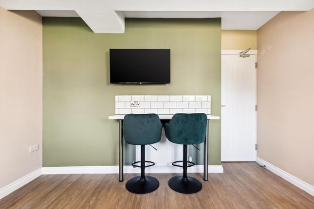 A Modern Communal Workspace Featuring A Sleek Bar-...
