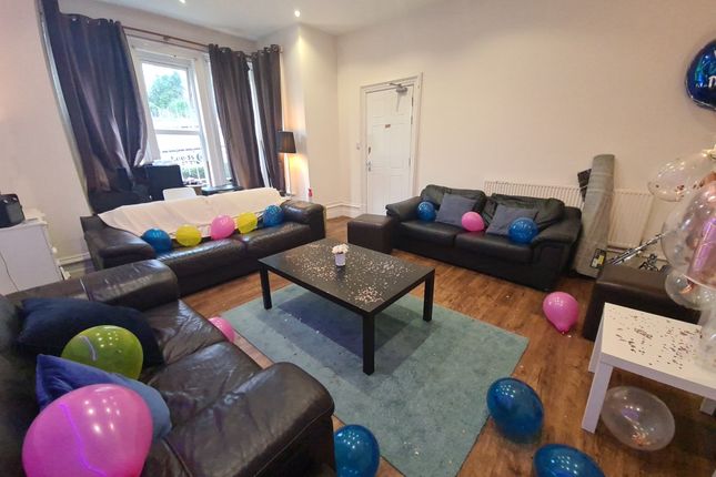 A Welcoming Living Room Featuring Three Black Leat...