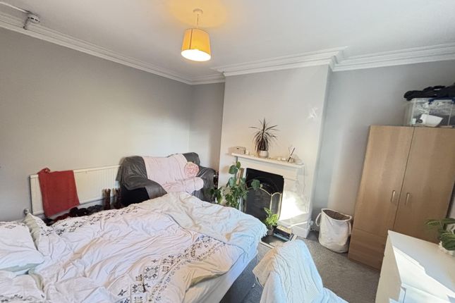 A Well-Lit And Inviting Living Room Featuring A Co...