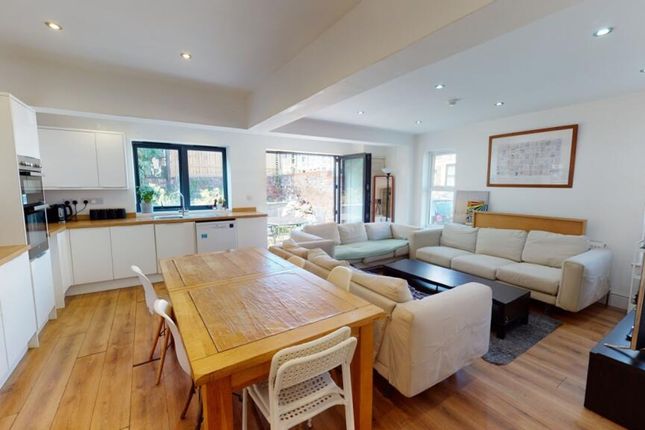 A Bright And Spacious Living Room Featuring Modern...