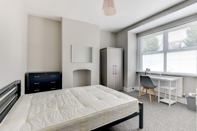 A Bright And Tidy Bedroom Featuring A Large Window...