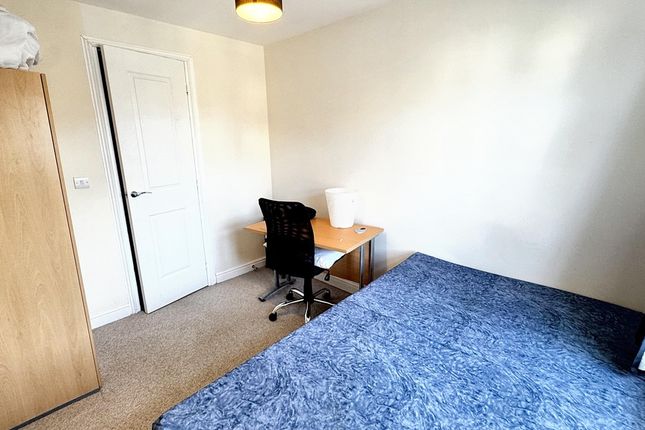 A Cozy Single Bedroom Featuring A Neatly Made Bed ...