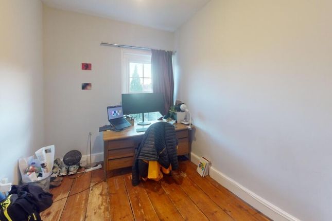 A Cozy Single Bedroom With Natural Light Coming Th...