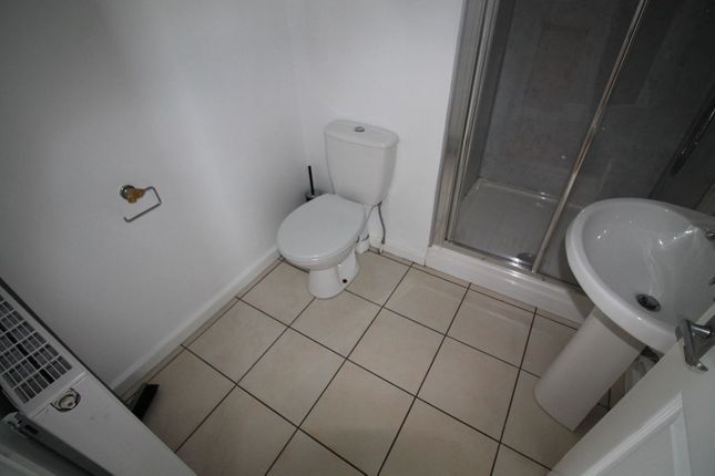 A Neat And Functional Bathroom Featuring A White T...