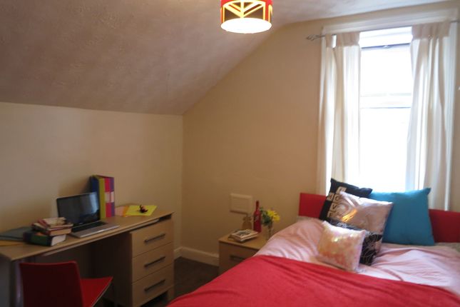 A Spacious And Well-Lit Master Bedroom With A Comf...