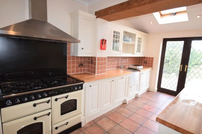 A Charming Kitchen Featuring Ample Counter Space A...