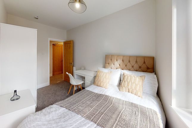 A Stylish And Inviting Double Bedroom With Ample N...
