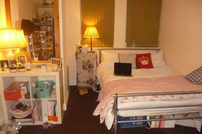 A Cozy Bedroom With A Neatly Made Bed, Bedside Lam...