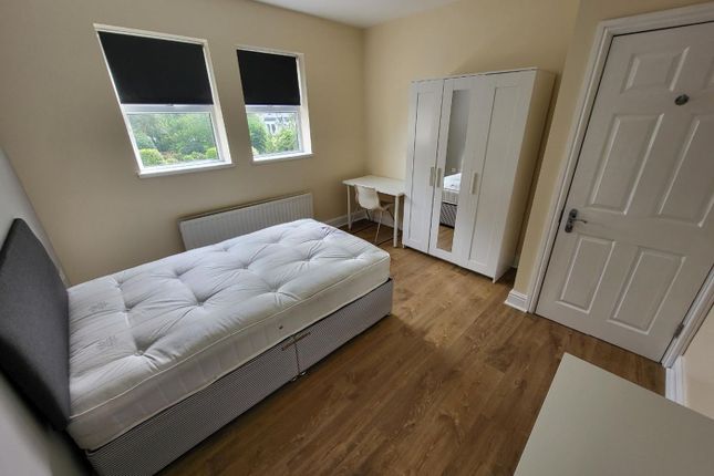 This Inviting Double Bedroom Features A Comfortabl...