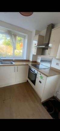 A Bright, Modern Kitchen With A Large Window Provi...