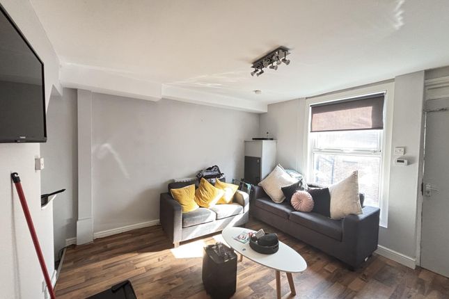 Bright And Inviting Living Room With Ample Natural...