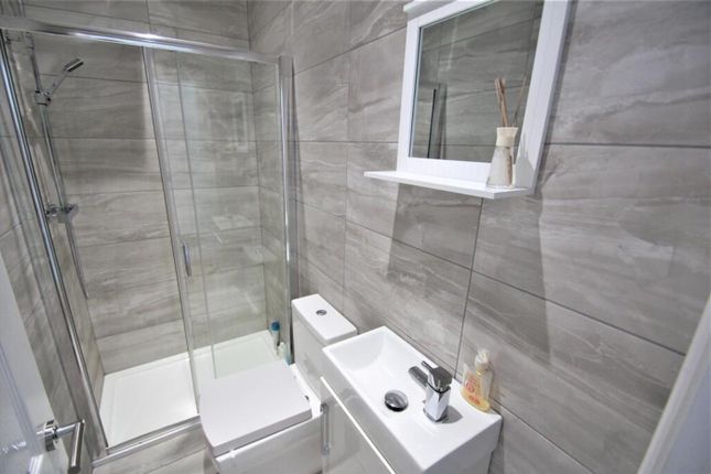 This Modern Bathroom Features Sleek Gray Tiles, A ...