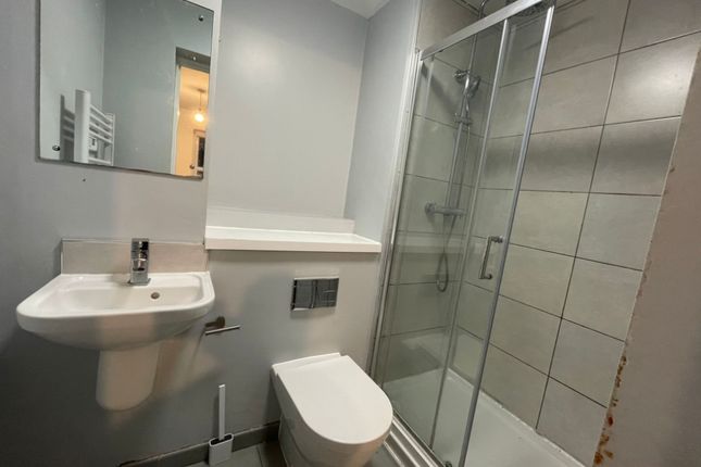 A Clean And Modern Bathroom Featuring A Glass-Encl...