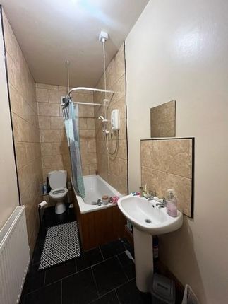 A Bright And Tidy Bathroom Featuring A Bathtub Wit...