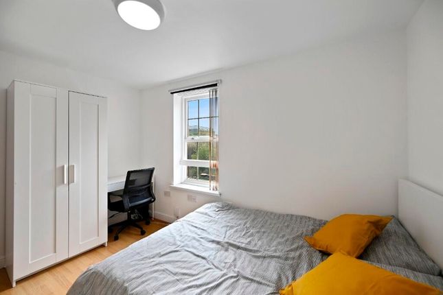 A Bright And Clean Master Bedroom Featuring A Comf...