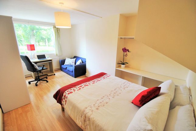 A Cozy Double Bedroom Featuring A Comfortable Bed,...