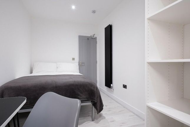A Bright, Modern Bedroom Featuring A Comfortable d...