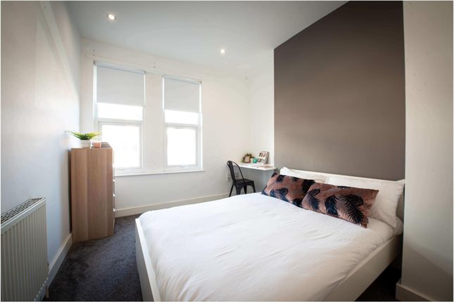 A Bright And Clean Bedroom Featuring A Comfortable...