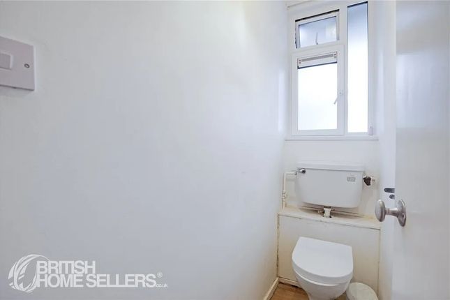 A Clean, Compact Bathroom With A White Toilet And ...