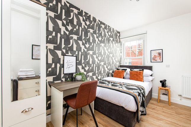 A Modern, Well-Lit Bedroom Featuring A Cozy Double...