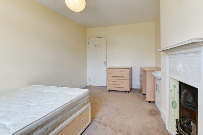 A Spacious Master Bedroom Featuring A Large Bed, A...