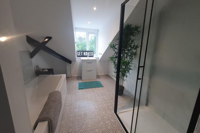 A Modern And Spacious Bathroom Suite Featuring A l...