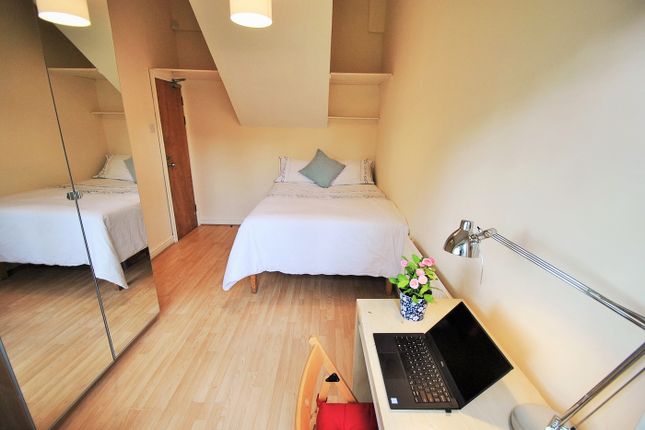 A Cozy Double Bedroom Featuring A Comfortable Bed,...