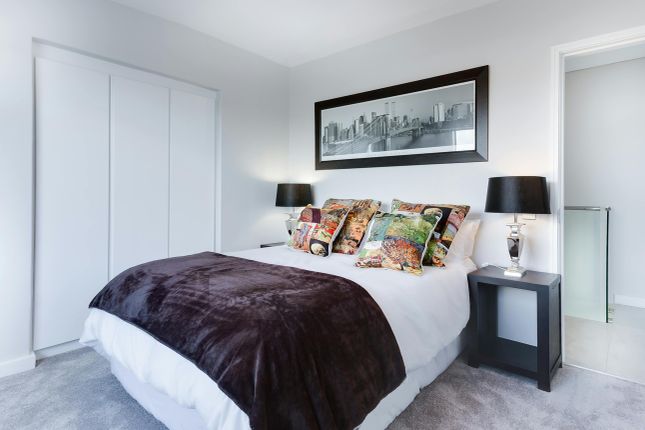 A Clean And Well-Lit Double Bedroom Featuring Deco...