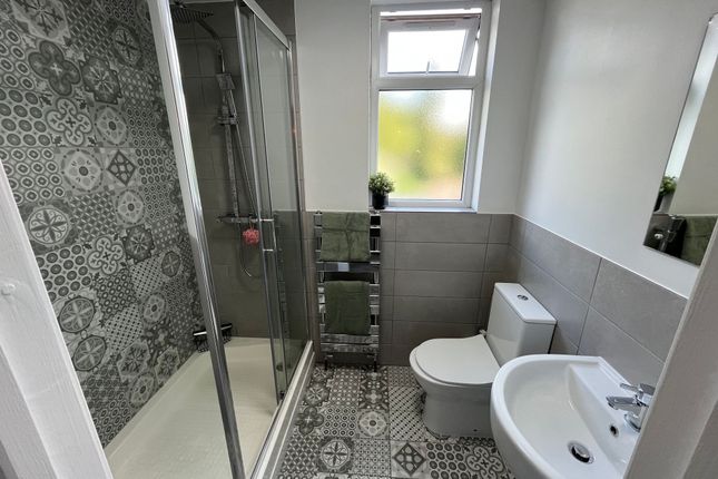 Bright And Modern Bathroom Featuring Patterned Til...