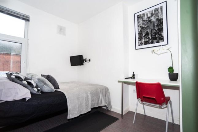 This Inviting Double Bedroom Features A Comfortabl...