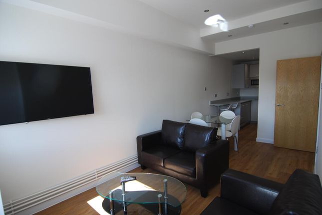 A Modern Living Room Featuring Sleek Black Leather...