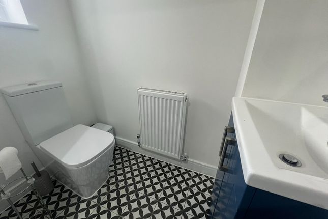 A Modern And Tidy Single Toilet Room Featuring Cle...