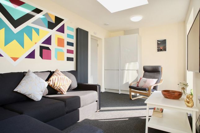 This Vibrant Living Room Features A Cozy Seating A...