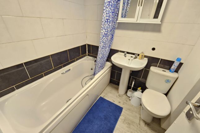 A Well-Maintained Bathroom Featuring A Bathtub Wit...