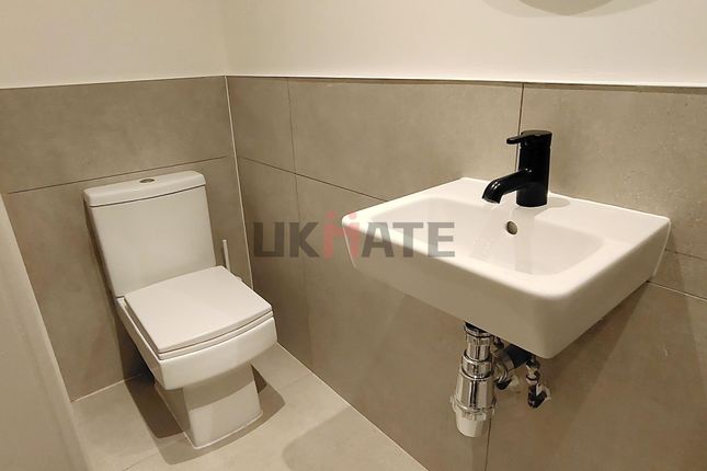 Modern Bathroom Featuring A Compact Sink With A Sl...