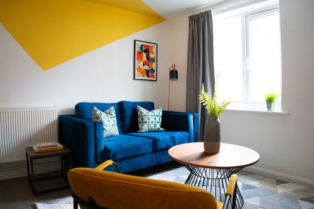 A Stylish And Bright Living Room Featuring A Comfo...