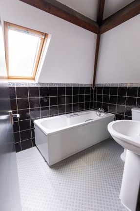 Bright And Clean Bathroom Featuring A Spacious Bat...