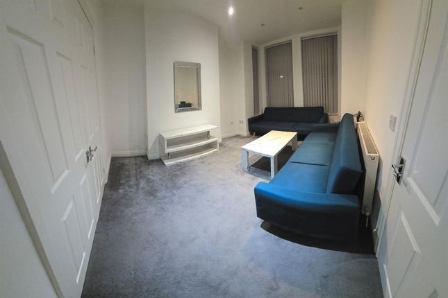 A Modern Living Room With A Blue Sofa, White Coffe...